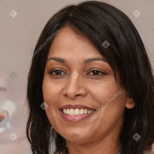 Joyful latino adult female with medium  brown hair and brown eyes