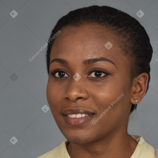 Joyful black young-adult female with short  black hair and brown eyes