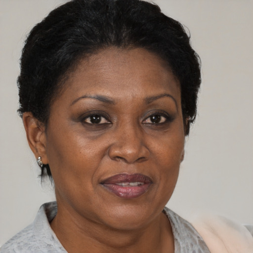 Joyful black adult female with short  brown hair and brown eyes