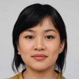 Joyful asian young-adult female with medium  black hair and brown eyes
