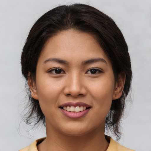 Joyful asian young-adult female with medium  brown hair and brown eyes