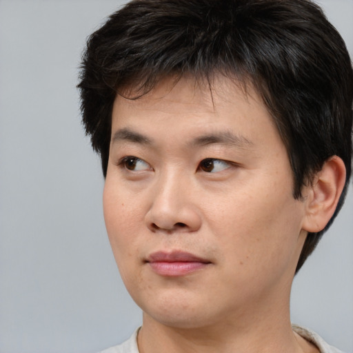 Neutral asian young-adult male with short  brown hair and brown eyes