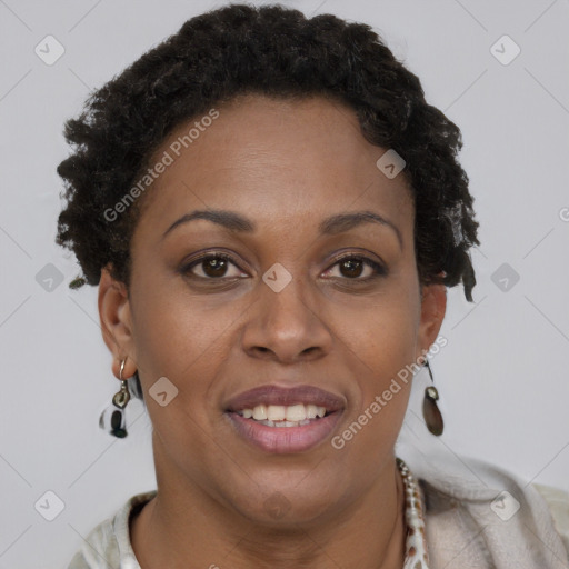 Joyful black adult female with short  brown hair and brown eyes