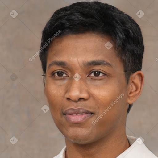 Joyful black young-adult male with short  black hair and brown eyes