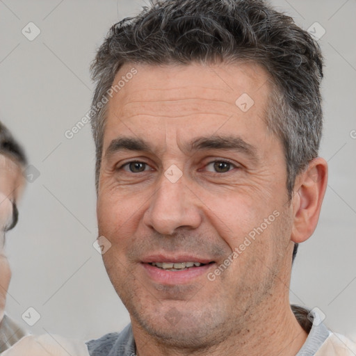 Joyful white adult male with short  brown hair and brown eyes