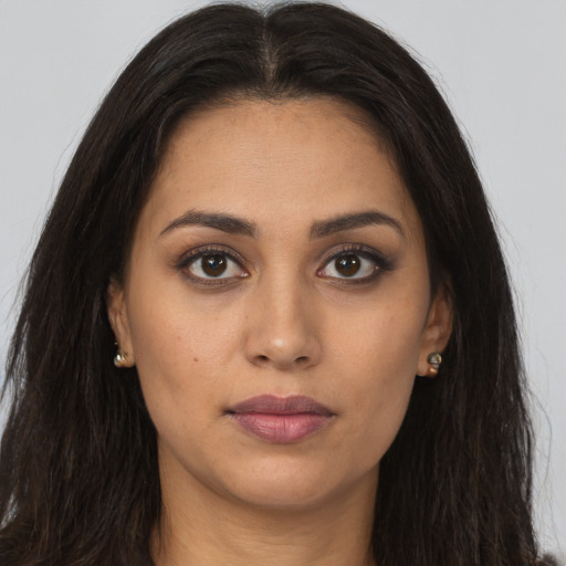 Joyful latino young-adult female with long  brown hair and brown eyes