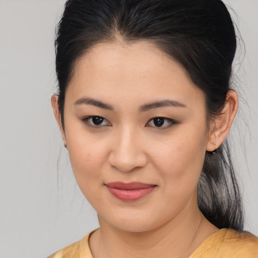 Joyful asian young-adult female with medium  brown hair and brown eyes