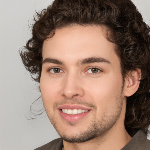 Joyful white young-adult male with medium  brown hair and brown eyes