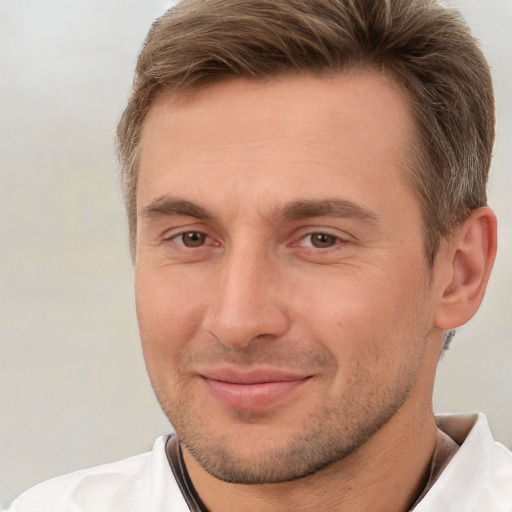 Joyful white adult male with short  brown hair and brown eyes