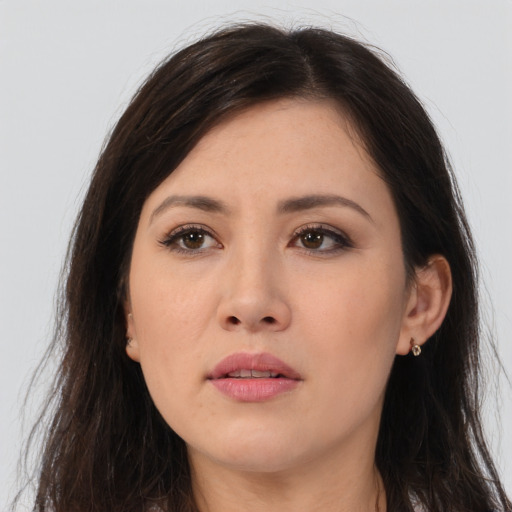 Joyful asian young-adult female with long  brown hair and brown eyes