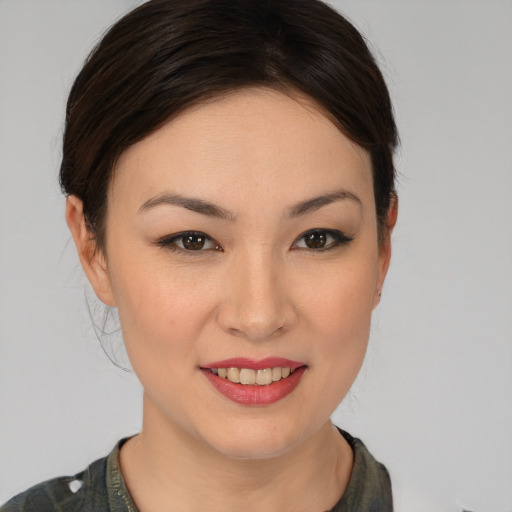 Joyful asian young-adult female with medium  brown hair and brown eyes