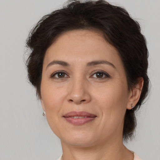 Joyful white adult female with medium  brown hair and brown eyes