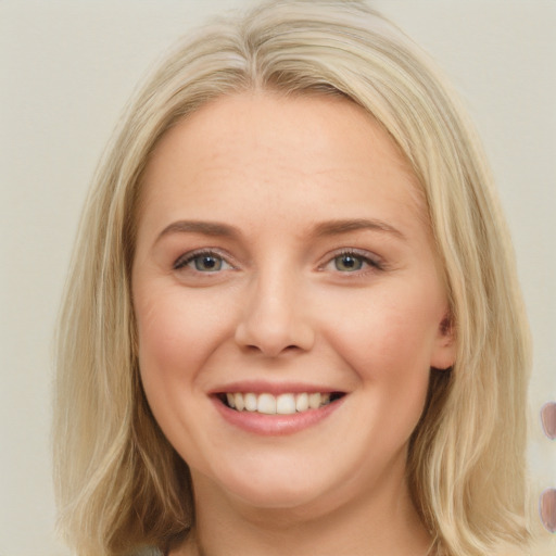 Joyful white young-adult female with long  brown hair and blue eyes