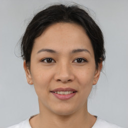 Joyful asian young-adult female with medium  brown hair and brown eyes