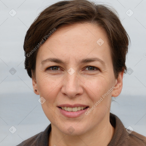 Joyful white adult female with short  brown hair and grey eyes