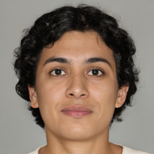 Joyful latino young-adult female with medium  brown hair and brown eyes