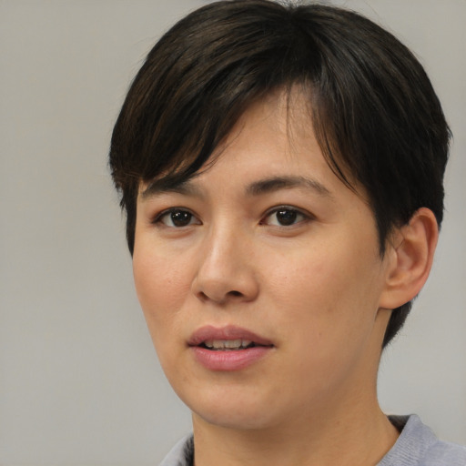 Joyful asian young-adult female with short  brown hair and brown eyes