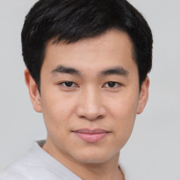 Joyful asian young-adult male with short  black hair and brown eyes