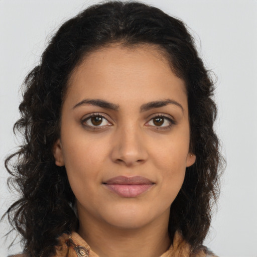 Joyful latino young-adult female with long  brown hair and brown eyes