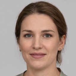 Joyful white adult female with medium  brown hair and grey eyes