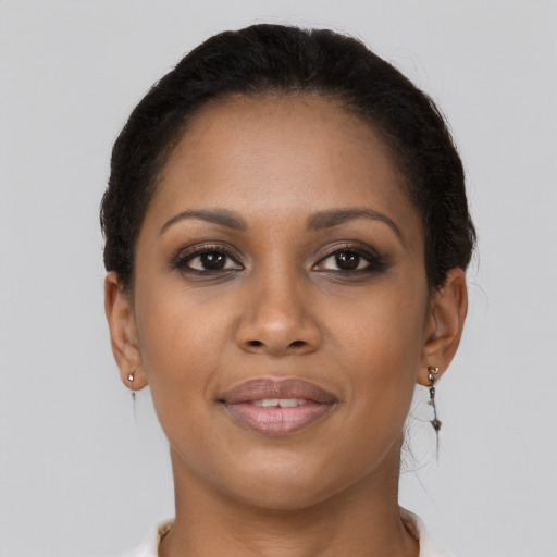 Joyful black young-adult female with short  brown hair and brown eyes