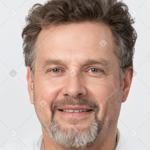 Joyful white adult male with short  brown hair and grey eyes