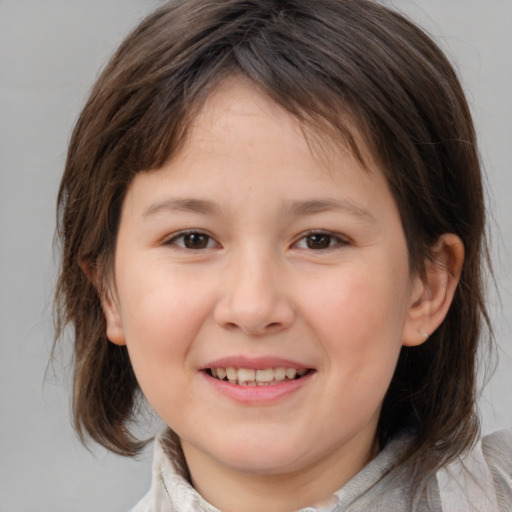 Joyful white child female with medium  brown hair and brown eyes