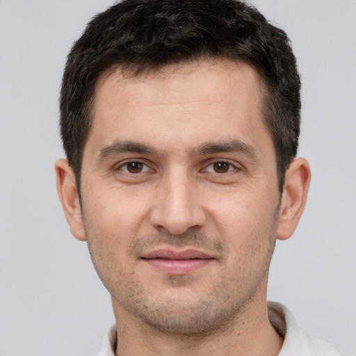 Joyful white young-adult male with short  brown hair and brown eyes