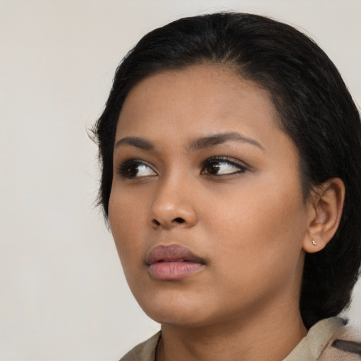 Neutral latino young-adult female with medium  black hair and brown eyes