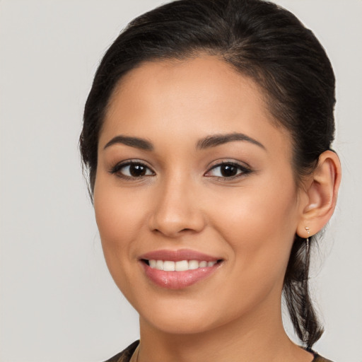 Joyful latino young-adult female with long  brown hair and brown eyes