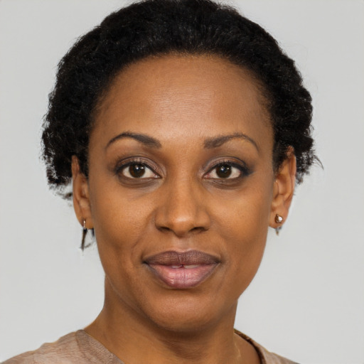 Joyful black adult female with short  black hair and brown eyes