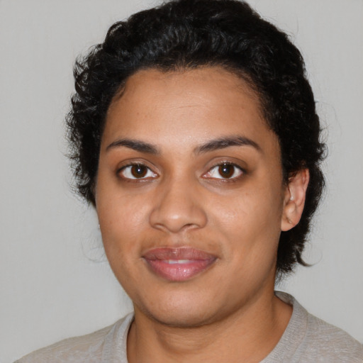 Joyful latino young-adult female with short  black hair and brown eyes