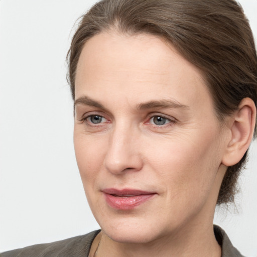 Joyful white adult female with medium  brown hair and grey eyes