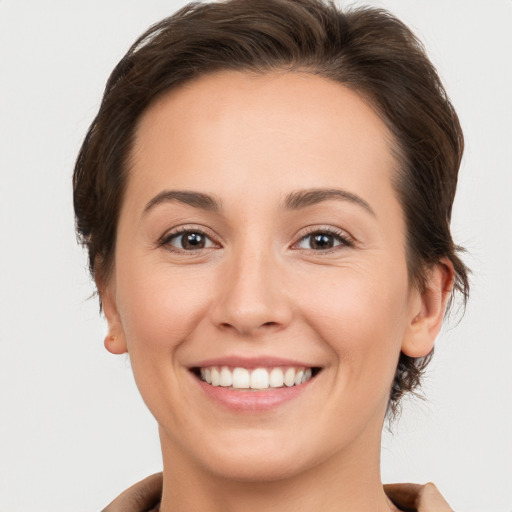 Joyful white young-adult female with short  brown hair and brown eyes