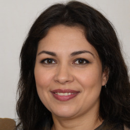 Joyful white adult female with long  brown hair and brown eyes