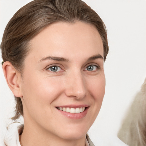 Joyful white young-adult female with medium  brown hair and grey eyes