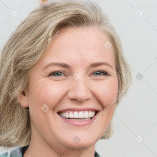 Joyful white adult female with medium  brown hair and blue eyes