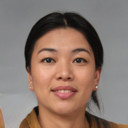 Joyful asian young-adult female with short  brown hair and brown eyes