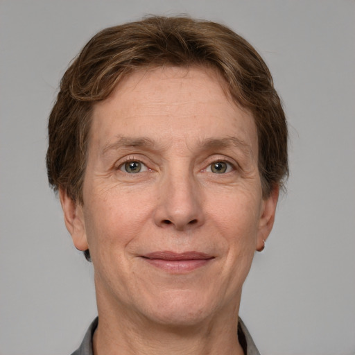 Joyful white adult female with short  brown hair and grey eyes