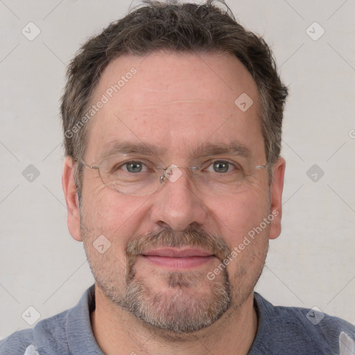 Joyful white adult male with short  brown hair and grey eyes