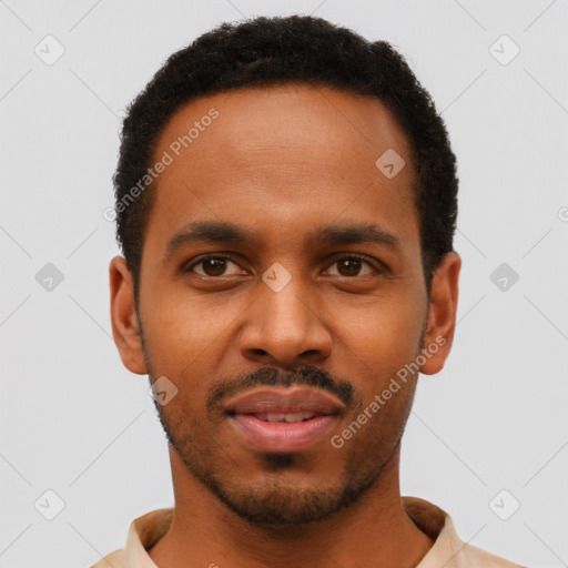 Joyful black young-adult male with short  black hair and brown eyes