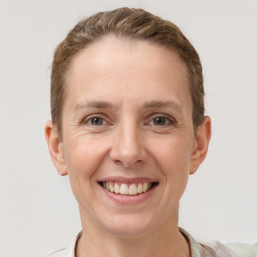 Joyful white adult female with short  brown hair and grey eyes