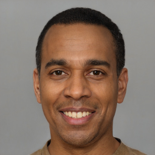 Joyful latino adult male with short  black hair and brown eyes