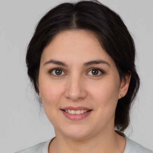 Joyful white young-adult female with medium  brown hair and brown eyes