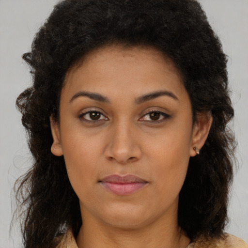 Joyful latino young-adult female with long  brown hair and brown eyes