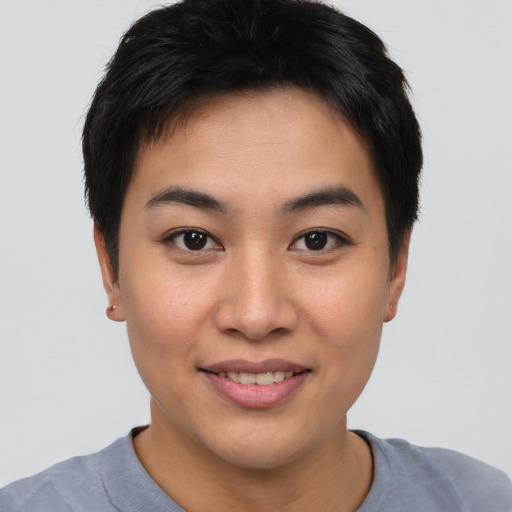 Joyful asian young-adult female with short  brown hair and brown eyes