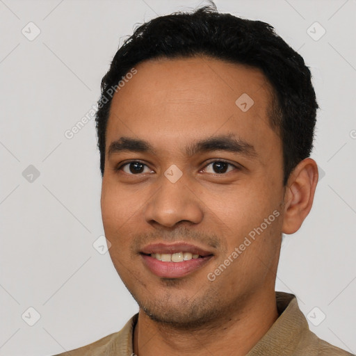 Joyful latino young-adult male with short  black hair and brown eyes