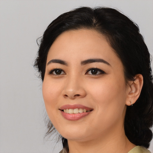 Joyful asian young-adult female with medium  black hair and brown eyes