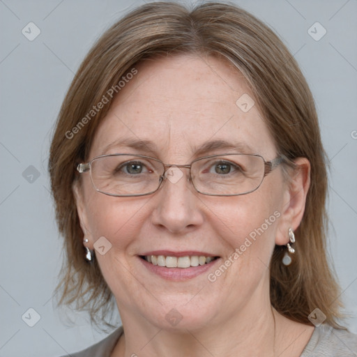 Joyful white adult female with medium  brown hair and blue eyes