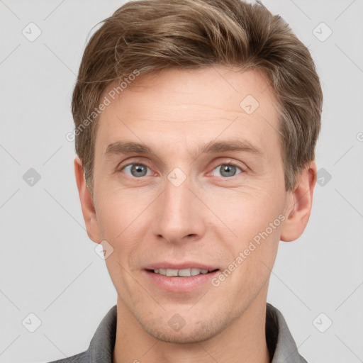 Joyful white adult male with short  brown hair and grey eyes